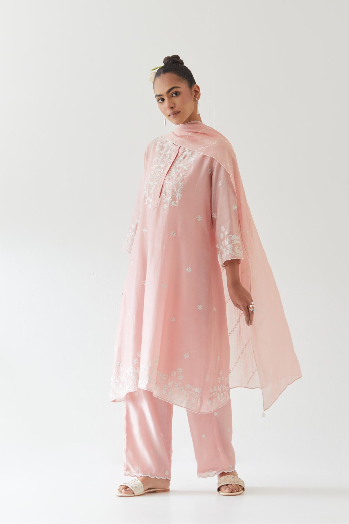 Pink silk chanderi short A-line kurta set highlighted with off white thread embroidery.