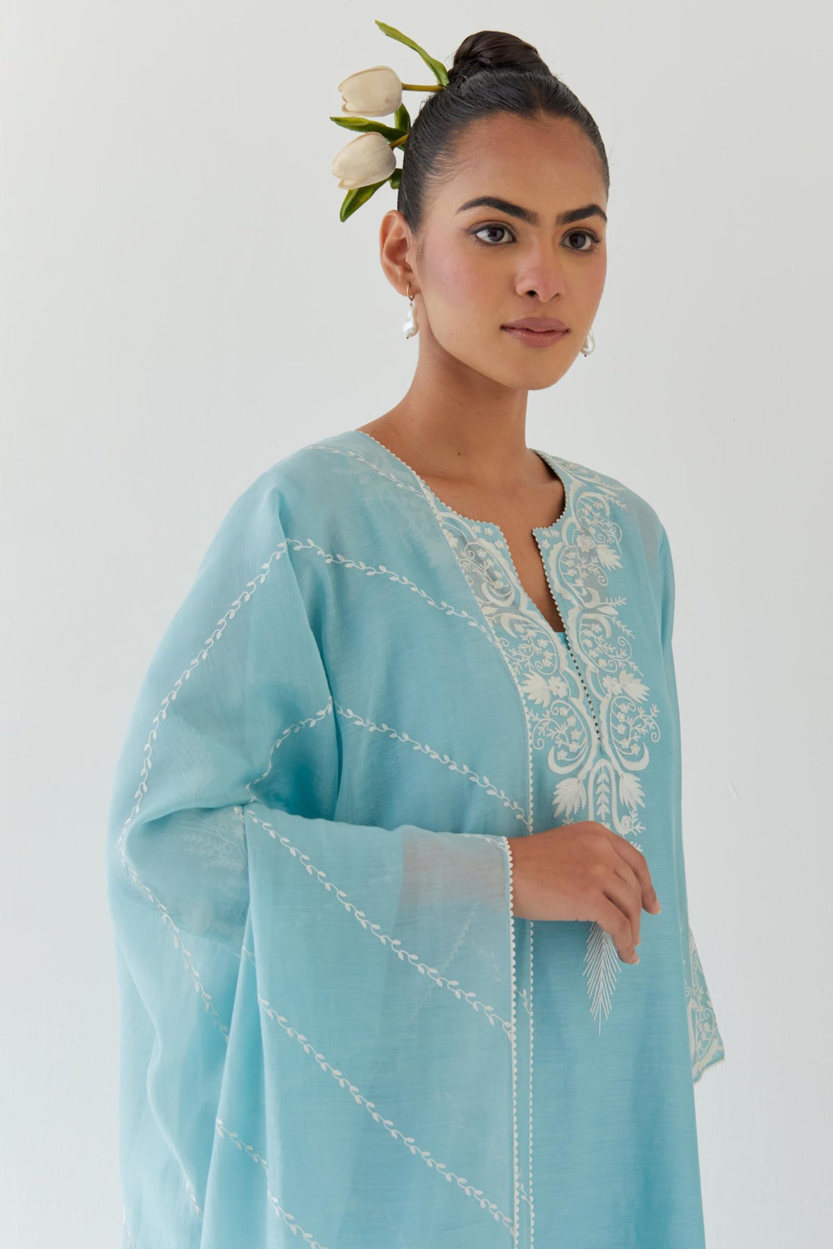 Blue silk chanderi straight kurta set highlighted with off white thread embroidery.