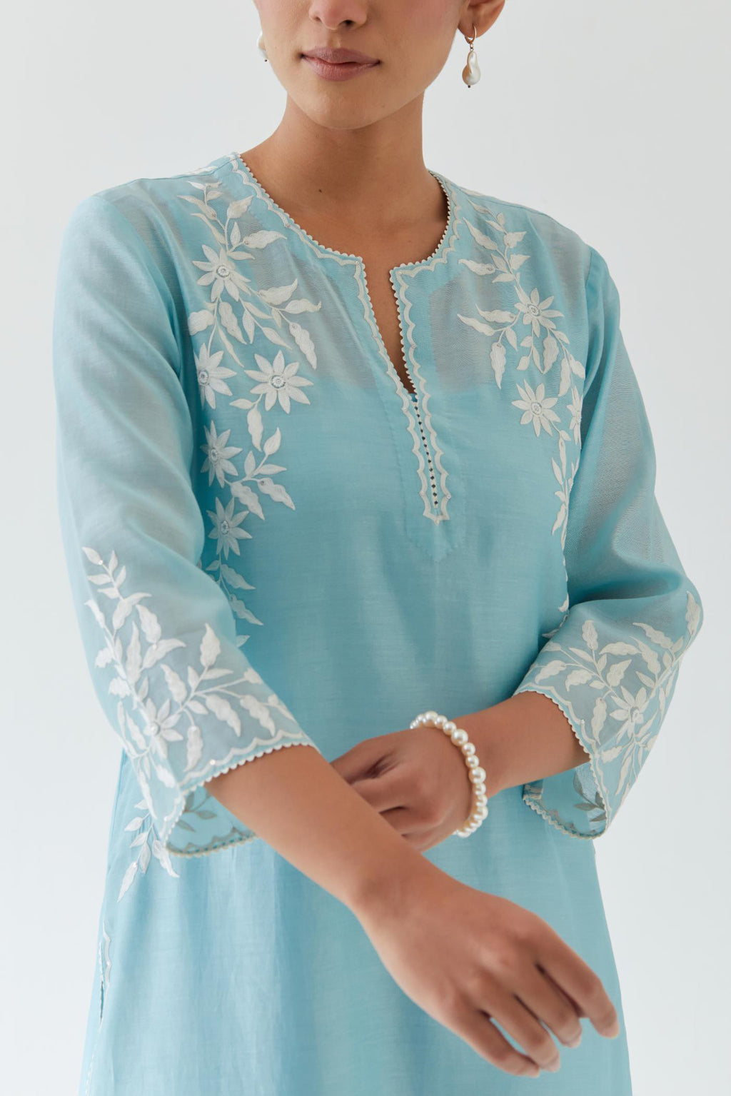 Blue silk chanderi straight kurta set highlighted with off white thread embroidery.