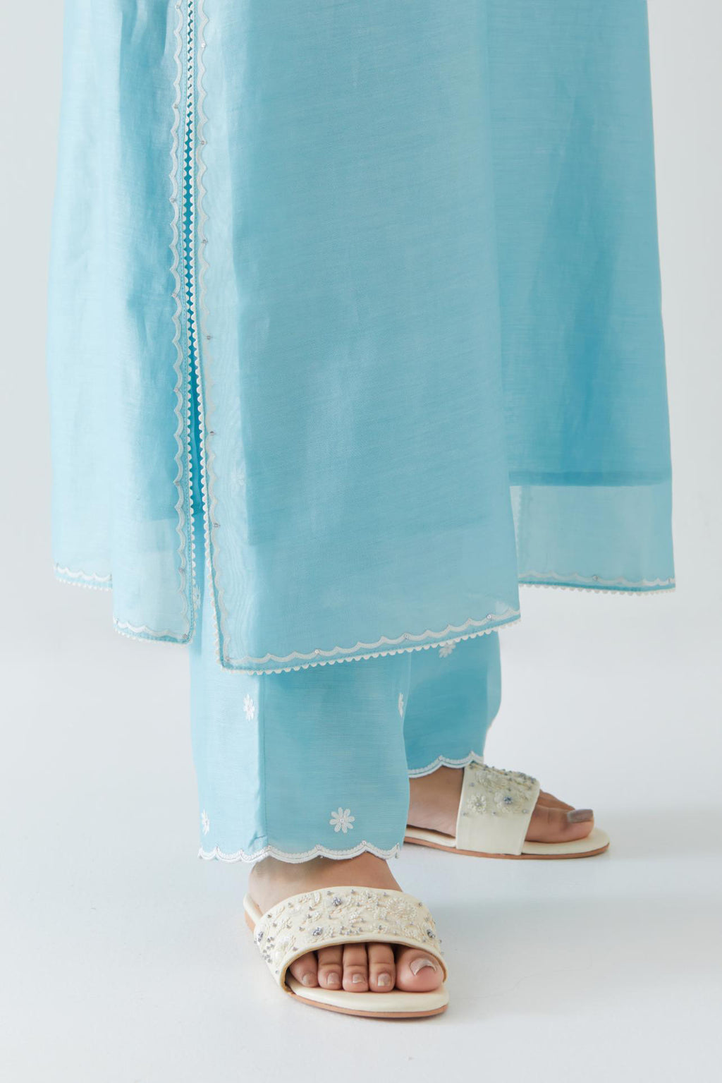 Blue silk chanderi straight kurta set highlighted with off white thread embroidery.