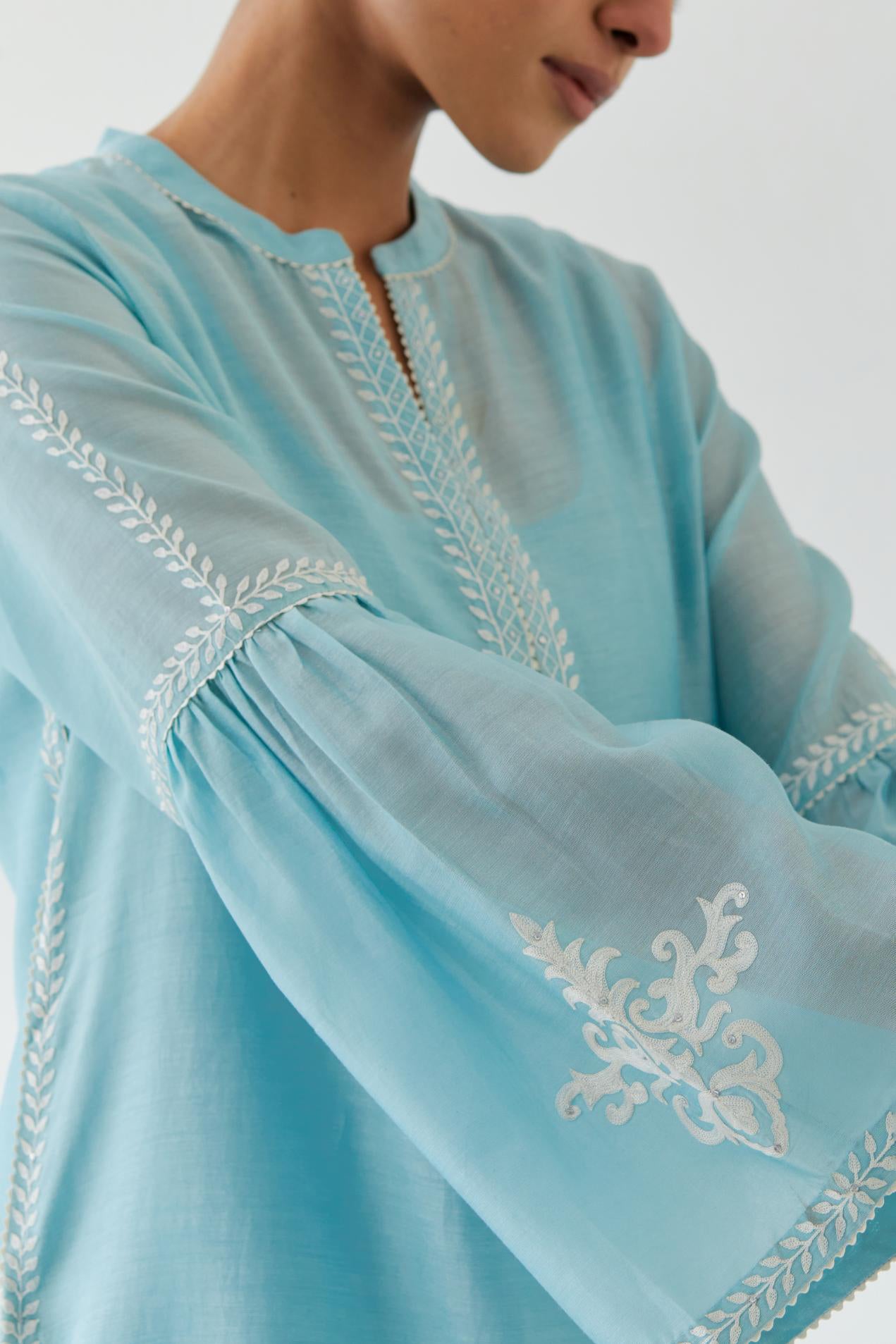 Blue silk chanderi straight kurta set with long bell sleeves, highlighted with off white thread embroidery.