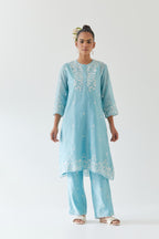 Blue silk chanderi short A-line kurta set highlighted with off white thread embroidery.
