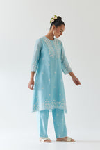 Blue silk chanderi short A-line kurta set highlighted with off white thread embroidery.