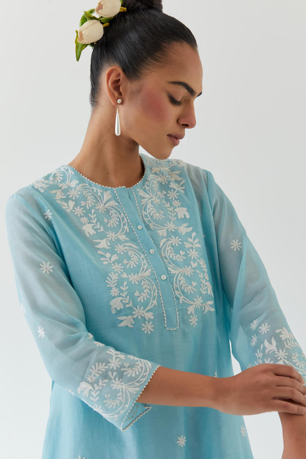 Blue silk chanderi short A-line kurta set highlighted with off white thread embroidery.