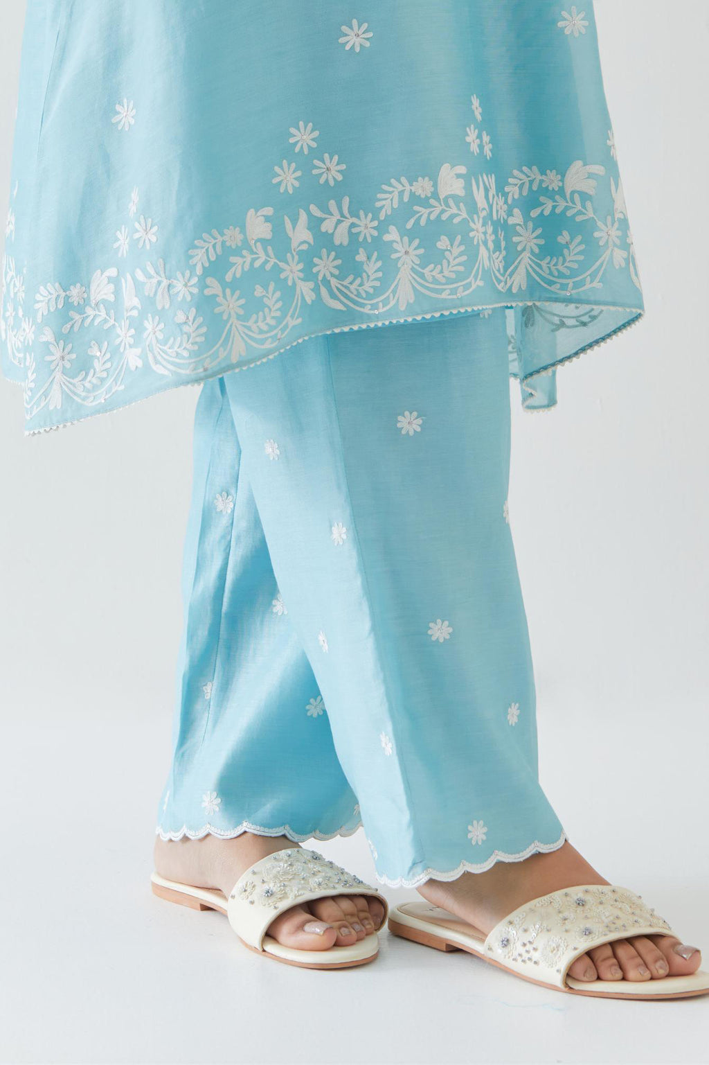 Blue silk chanderi short A-line kurta set highlighted with off white thread embroidery.