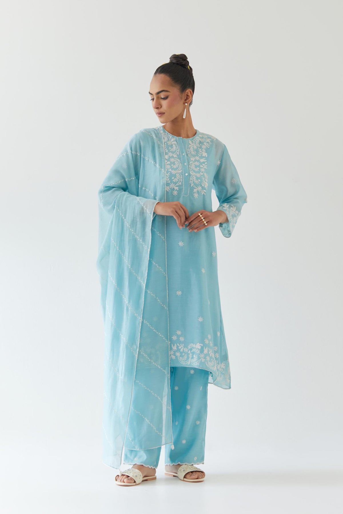 Blue silk chanderi short A-line kurta set highlighted with off white thread embroidery.