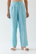 Blue silk chanderi straight pants with off white thread embroidery and scalloped edges at hem.