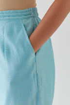 Blue silk chanderi straight pants with off white thread embroidery and scalloped edges at hem.
