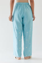 Blue silk chanderi straight pants with off white thread embroidery and scalloped edges at hem.