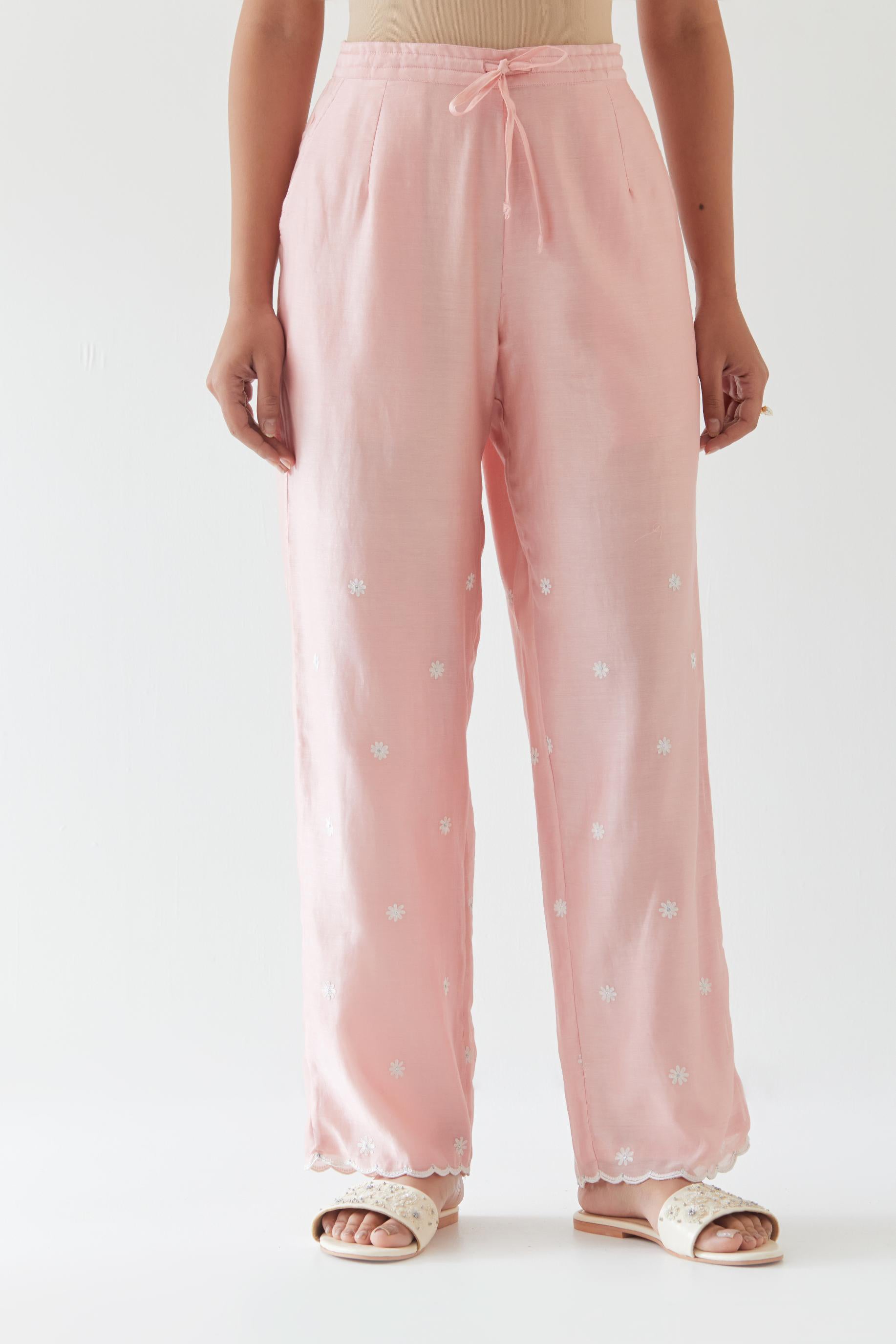 Pink silk chanderi straight pants with off white thread embroidery and scalloped edges at hem.