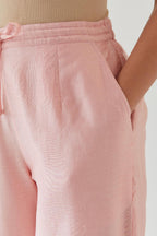 Pink silk chanderi straight pants with off white thread embroidery and scalloped edges at hem.