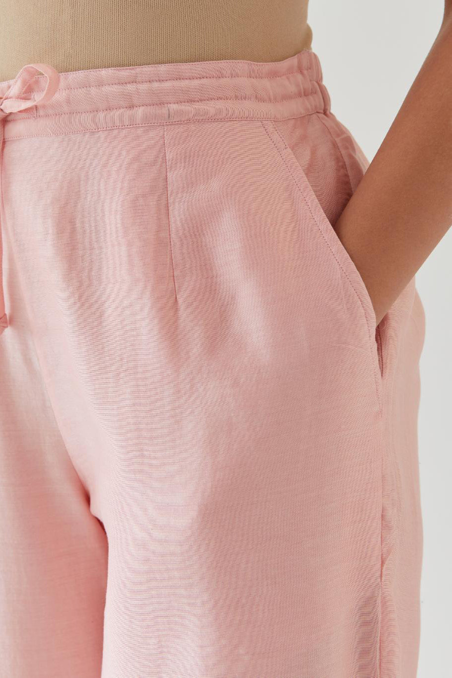 Pink silk chanderi straight pants with off white thread embroidery and scalloped edges at hem.