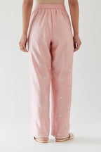 Pink silk chanderi straight pants with off white thread embroidery and scalloped edges at hem.