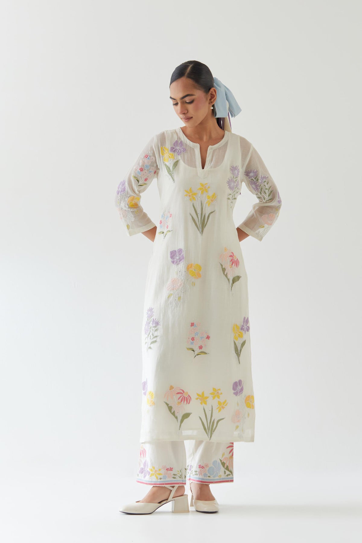Off white cotton straight kurta set with all-over multi colored applique, highlighted with bead & sequins work.