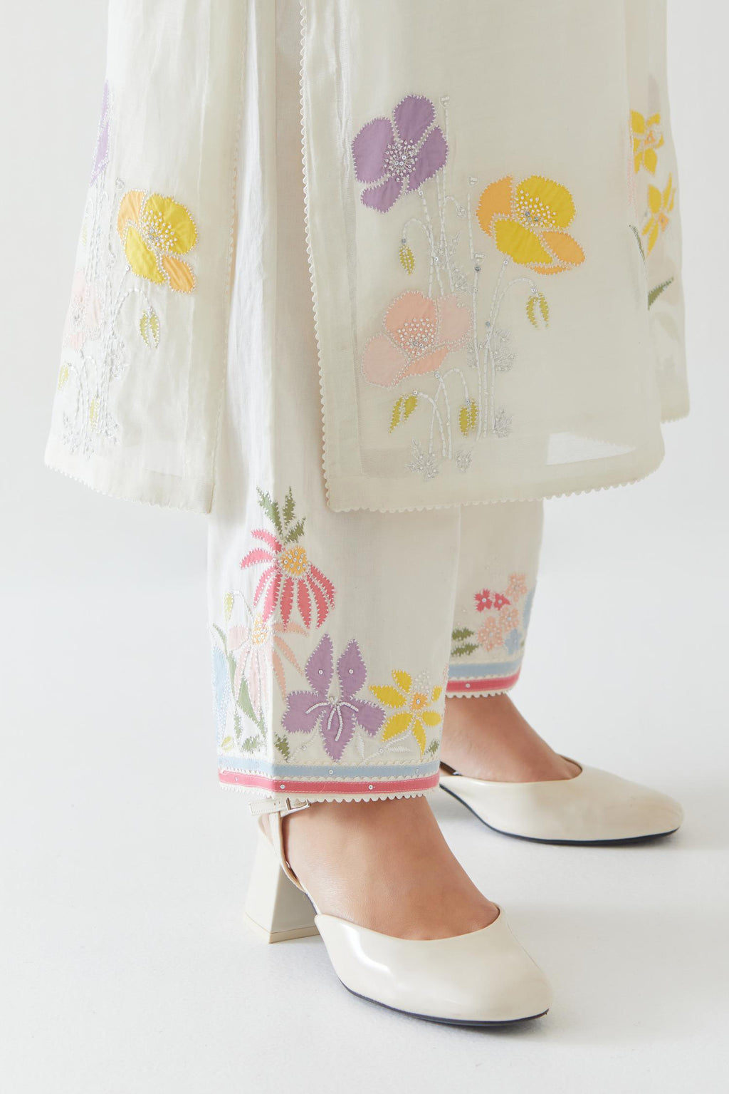 Off white cotton straight kurta set with all-over multi colored applique, highlighted with bead & sequins work.