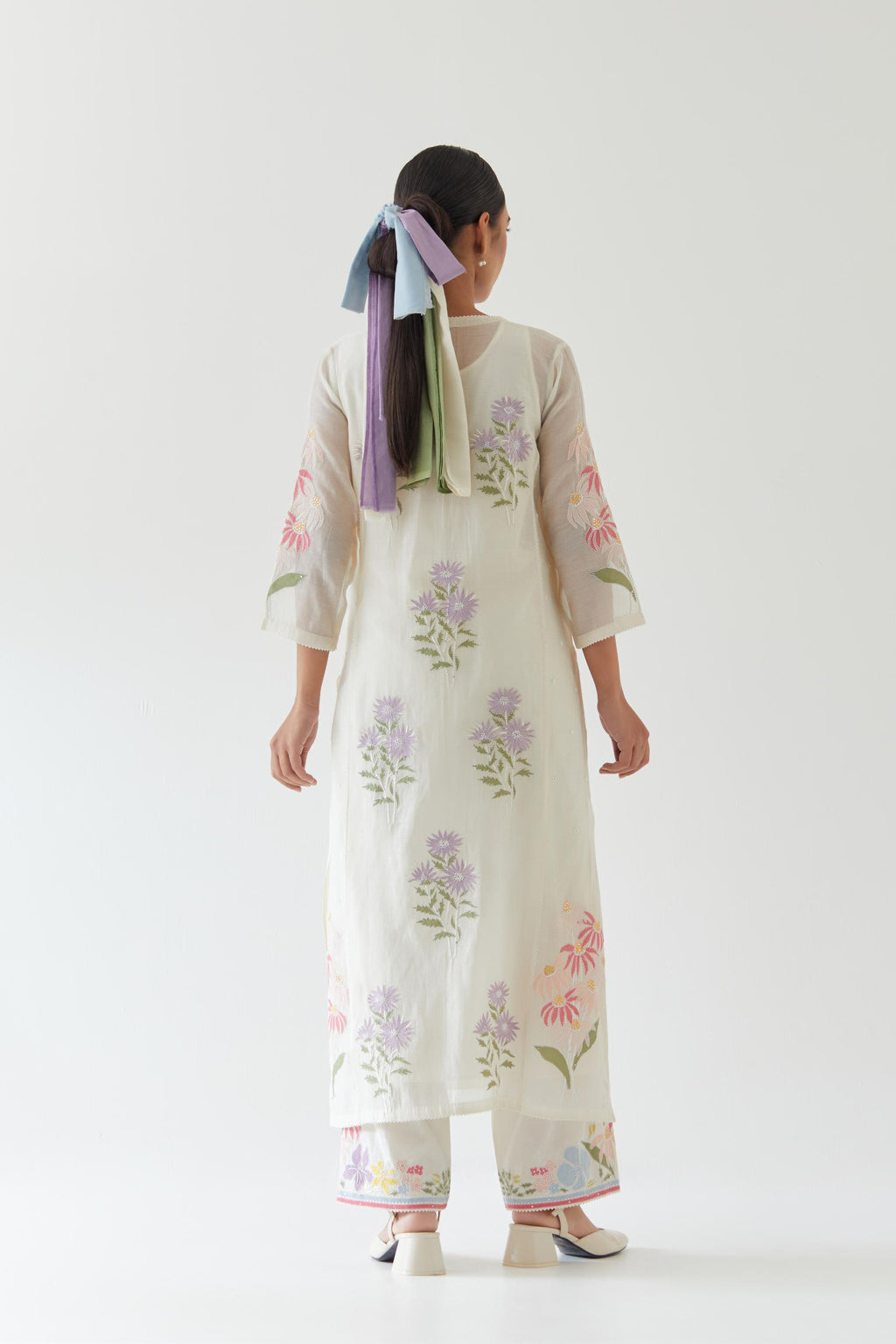 Off white cotton straight side paneled kurta set with all-over multi colored applique, highlighted with bead & sequins work.