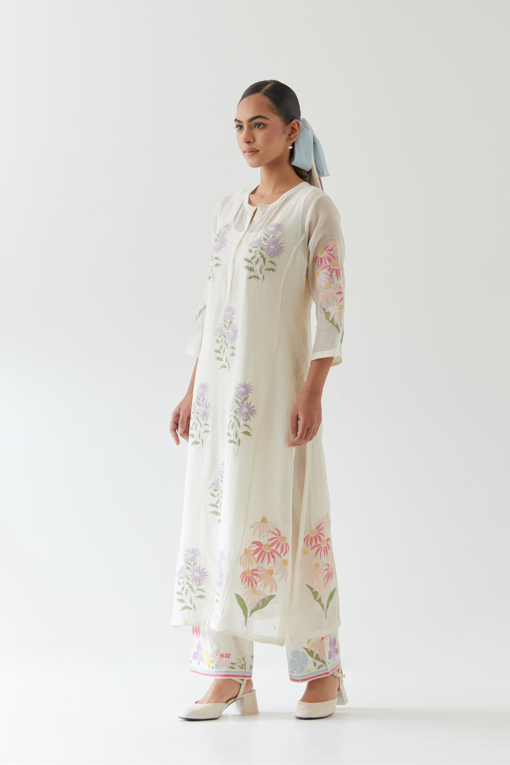 Off white cotton straight side paneled kurta set with all-over multi colored applique, highlighted with bead & sequins work.