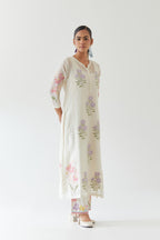 Off white cotton straight side paneled kurta set with all-over multi colored applique, highlighted with bead & sequins work.