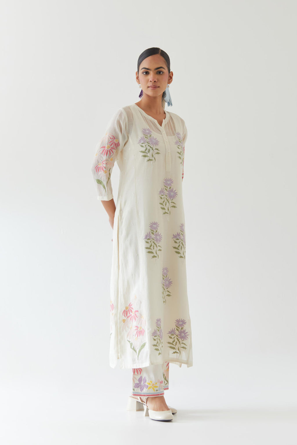 Off white cotton straight side paneled kurta set with all-over multi colored applique, highlighted with bead & sequins work.