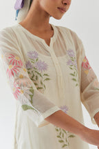 Off white cotton straight side paneled kurta set with all-over multi colored applique, highlighted with bead & sequins work.