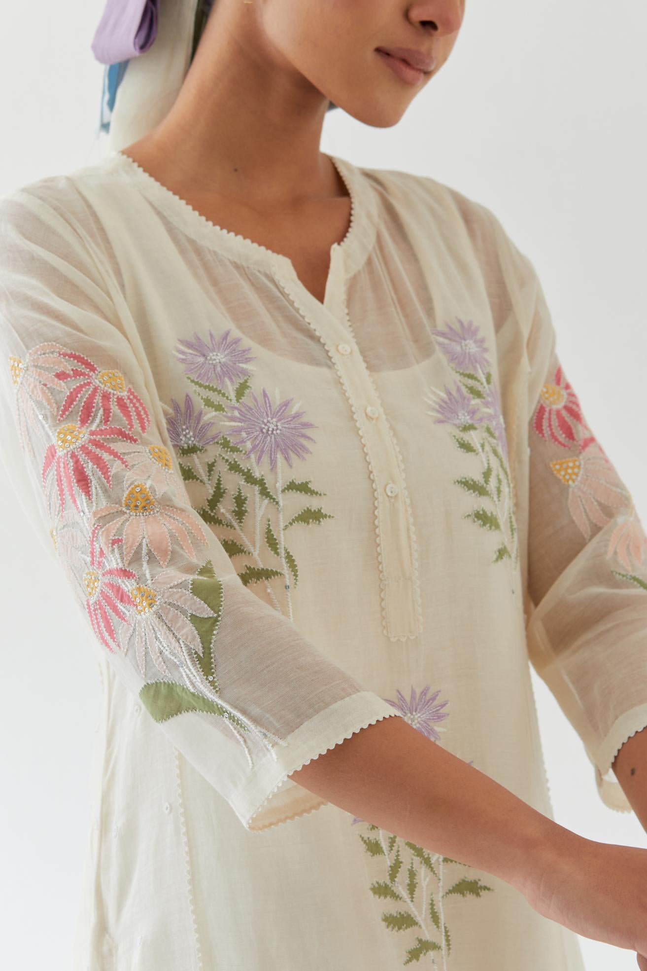 Off white cotton straight side paneled kurta set with all-over multi colored applique, highlighted with bead & sequins work.