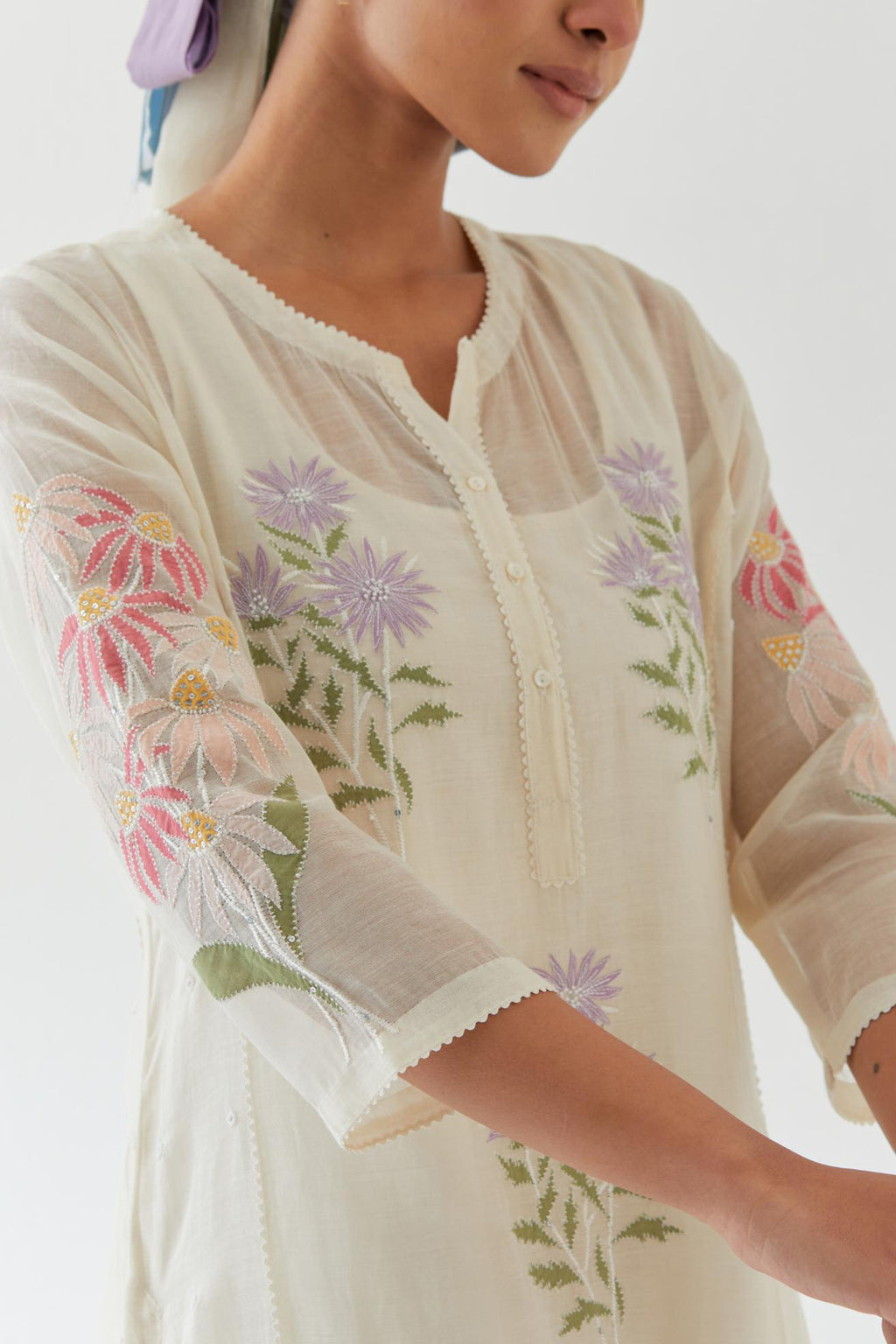 Off white cotton straight side paneled kurta set with all-over multi colored applique, highlighted with bead & sequins work.