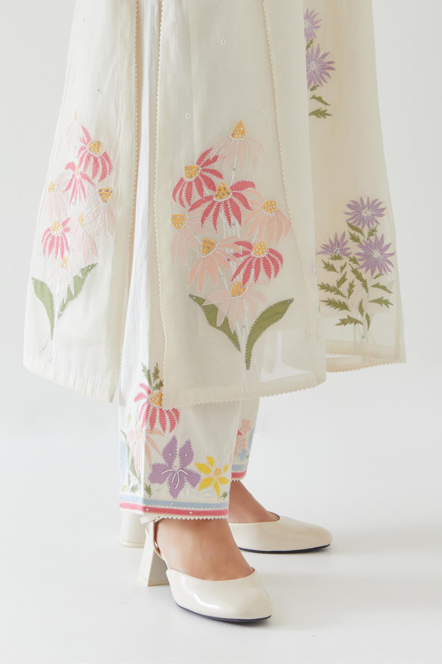 Off white cotton straight side paneled kurta set with all-over multi colored applique, highlighted with bead & sequins work.
