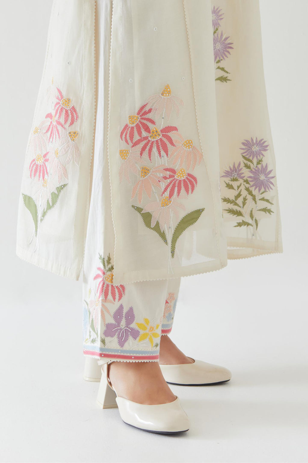 Off white cotton straight side paneled kurta set with all-over multi colored applique, highlighted with bead & sequins work.