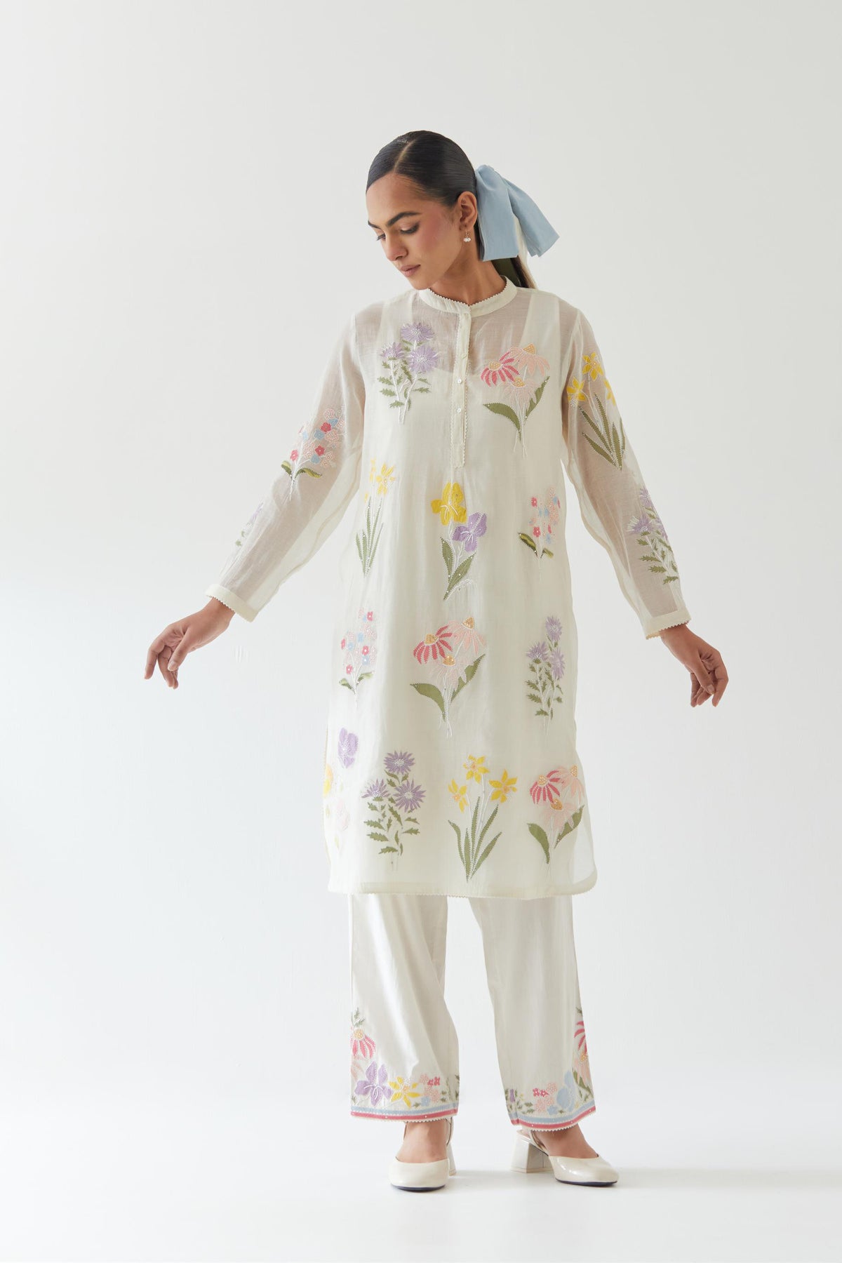 Off white cotton chanderi straight short easy fit kurta set with all-over multi colored assorted flower applique, highlighted with bead & sequins work.