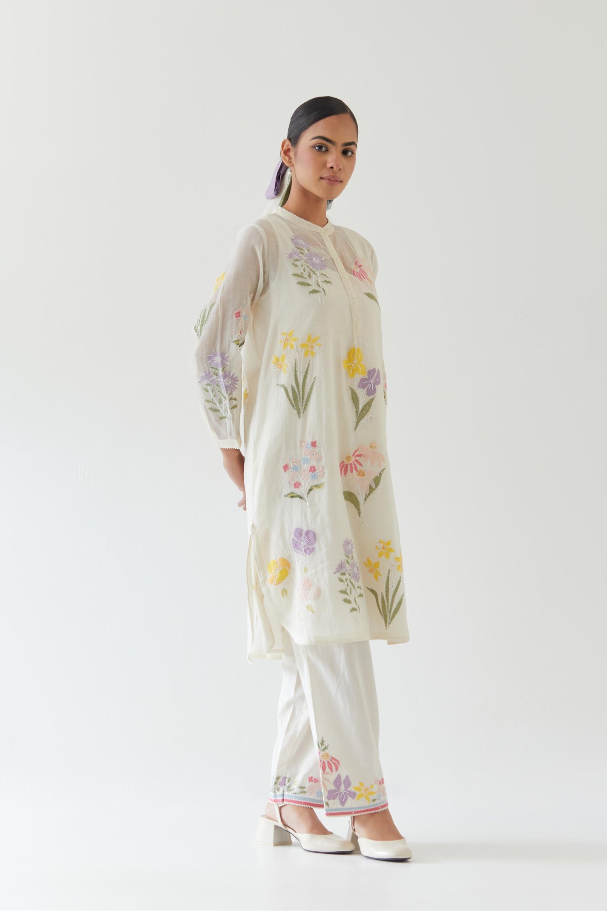 Off white cotton chanderi straight short easy fit kurta set with all-over multi colored assorted flower applique, highlighted with bead & sequins work.