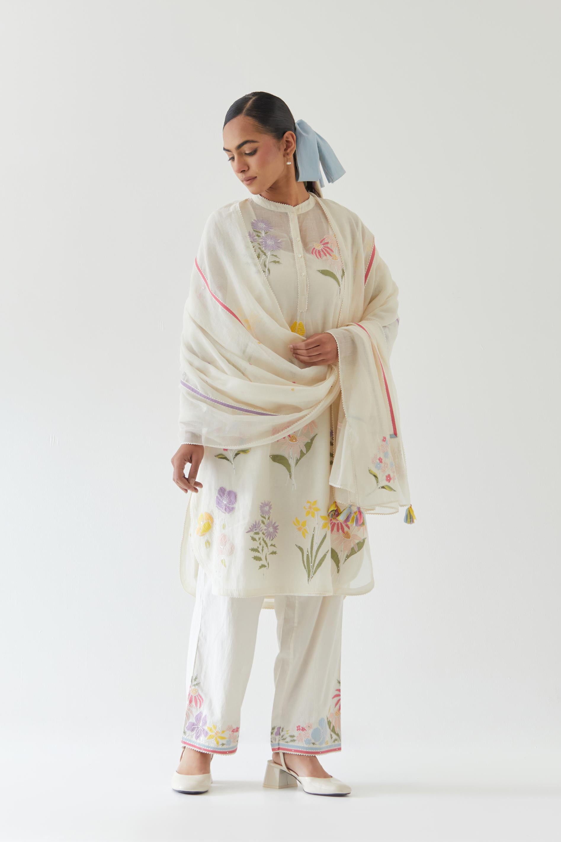 Off white cotton chanderi straight short easy fit kurta set with all-over multi colored assorted flower applique, highlighted with bead & sequins work.
