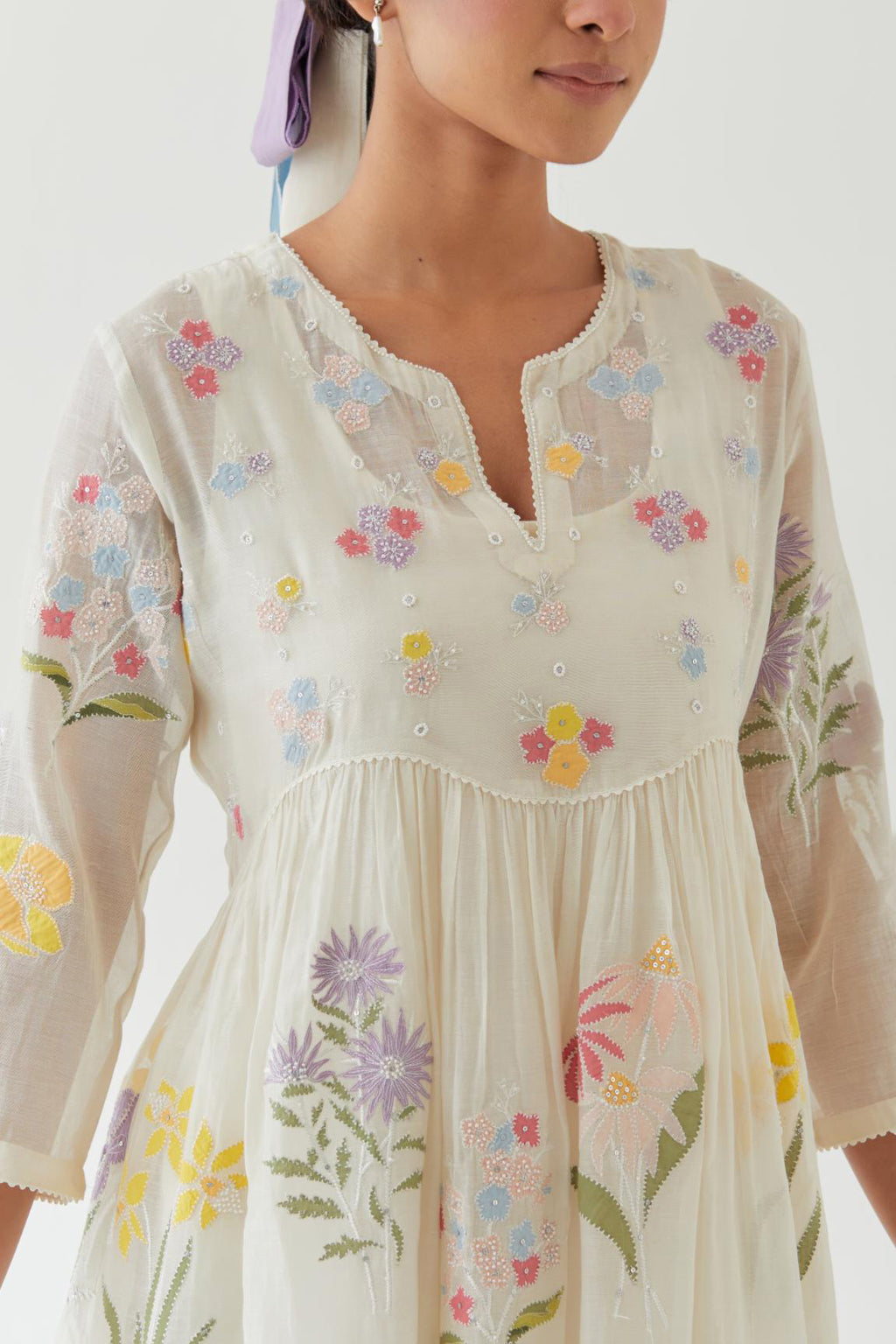 Off white cotton chanderi Kurta set dress with all-over multi colored assorted flower applique, highlighted with bead and sequins.