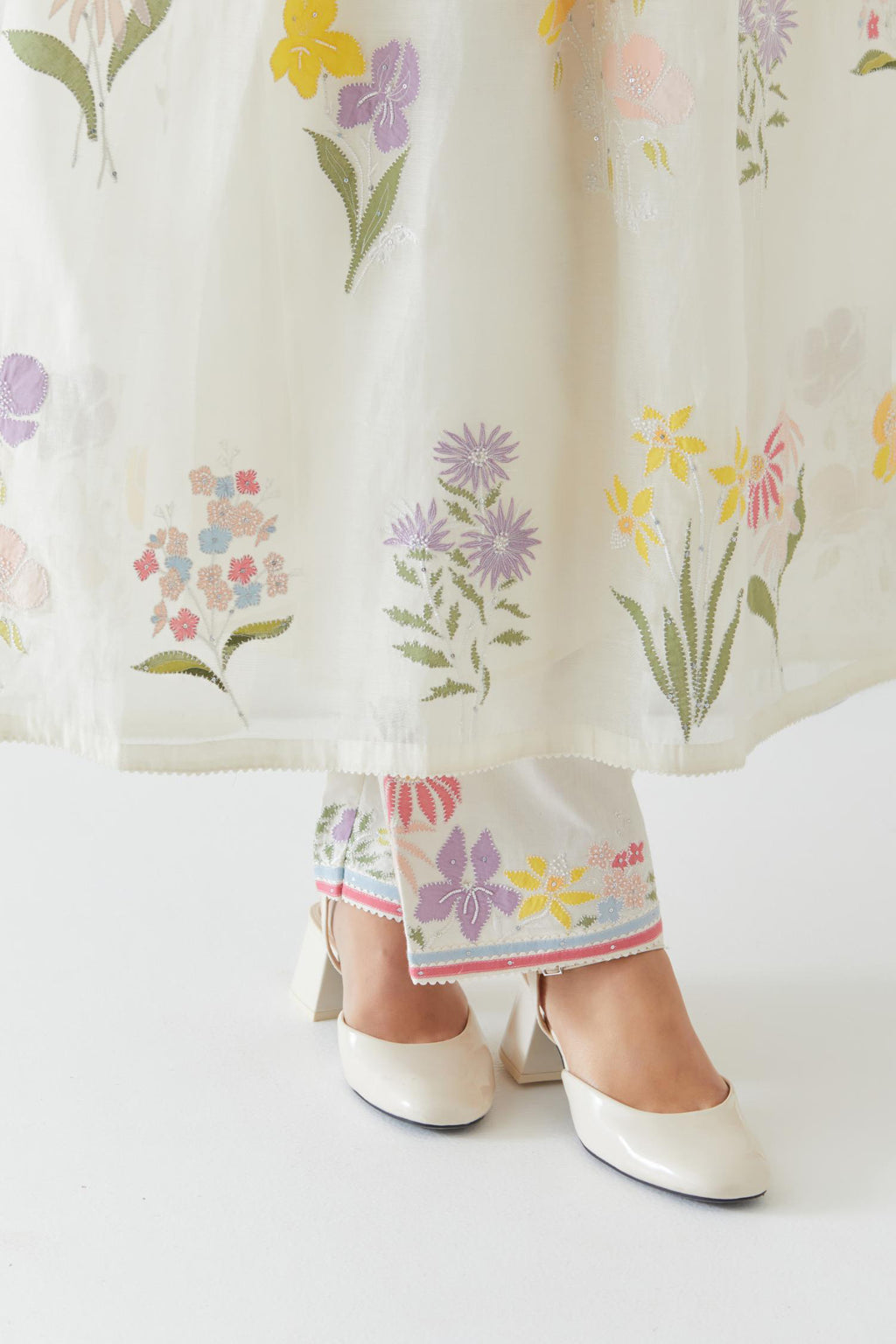 Off white cotton chanderi Kurta set dress with all-over multi colored assorted flower applique, highlighted with bead and sequins.