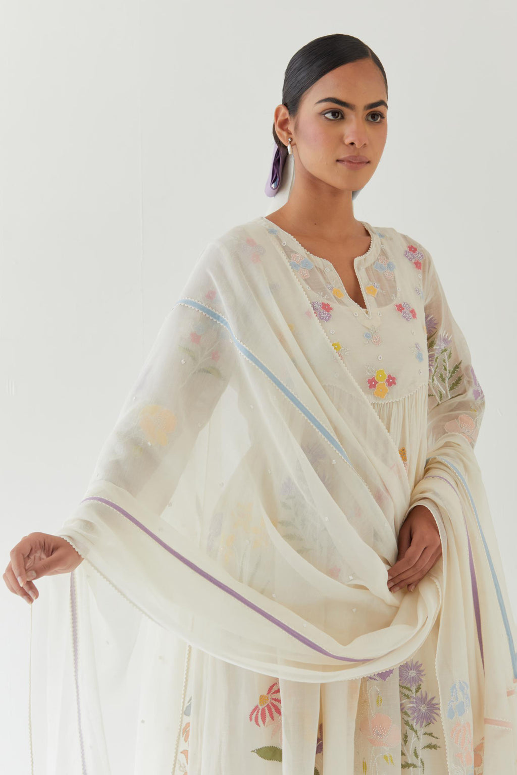 Off white cotton chanderi dupatta with multi colored applique, highlighted with bead & sequins work.