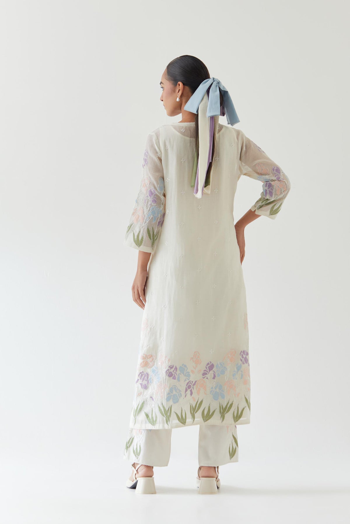 Off white cotton chanderi straight kurta set, decorated with appliqué at the hem and sleeves.