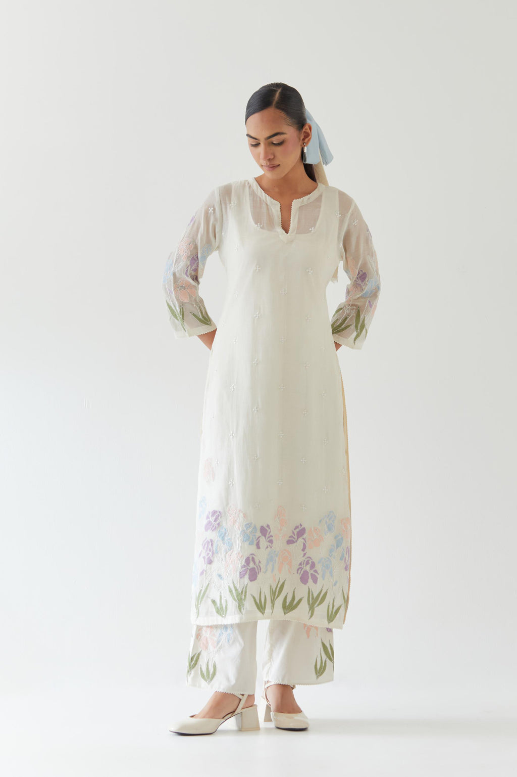 Off white cotton chanderi straight kurta set, decorated with appliqué at the hem and sleeves.
