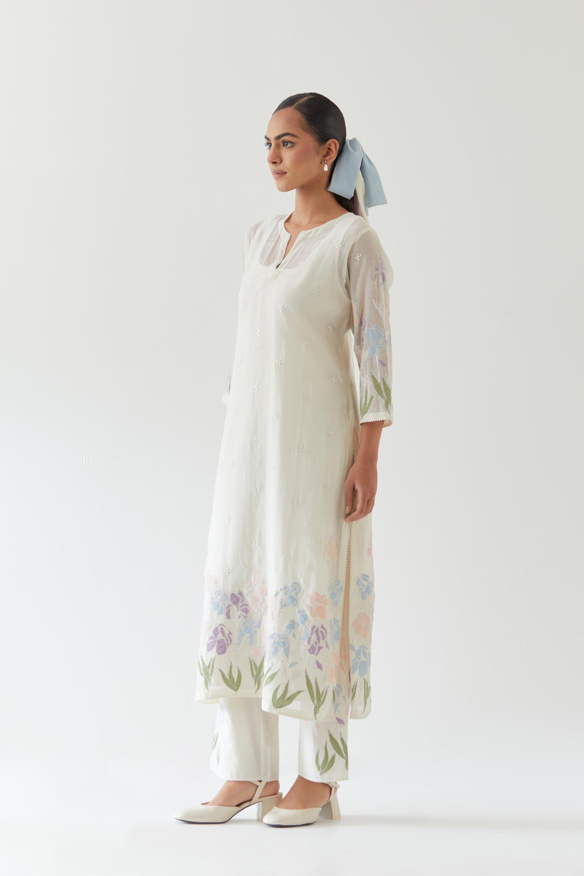 Off white cotton chanderi straight kurta set, decorated with appliqué at the hem and sleeves.