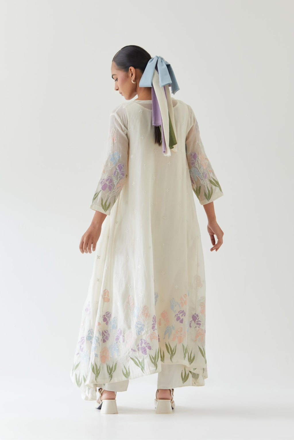 Off white cotton chanderi easy fit, asymmetric hem, paneled kurta set with applique work at hem and sleeves.