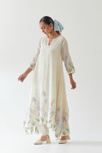 Off white cotton chanderi easy fit, asymmetric hem, paneled kurta set with applique work at hem and sleeves.