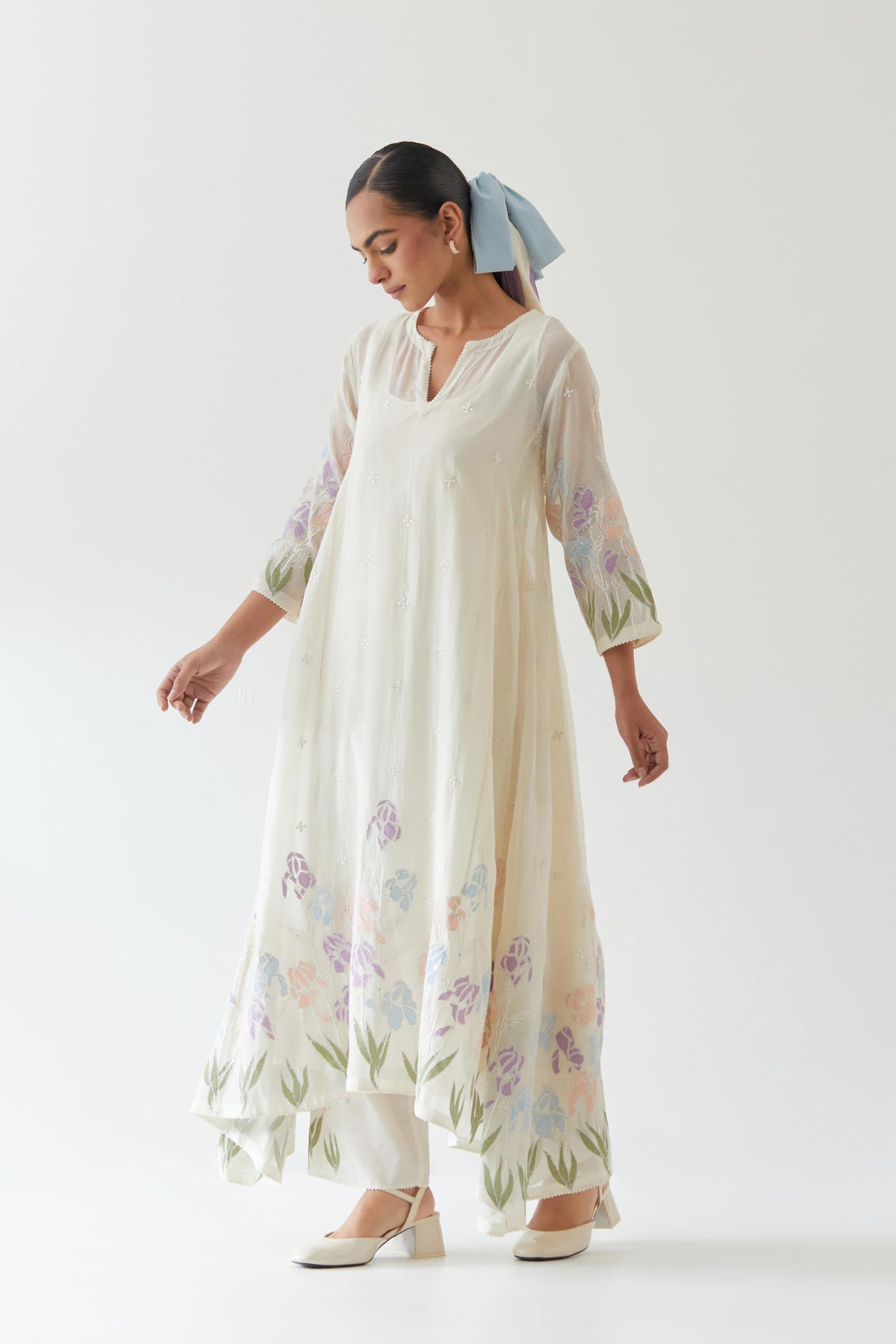 Off white cotton chanderi easy fit, asymmetric hem, paneled kurta set with applique work at hem and sleeves.