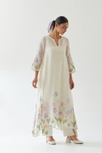 Off white cotton chanderi easy fit, asymmetric hem, paneled kurta set with applique work at hem and sleeves.