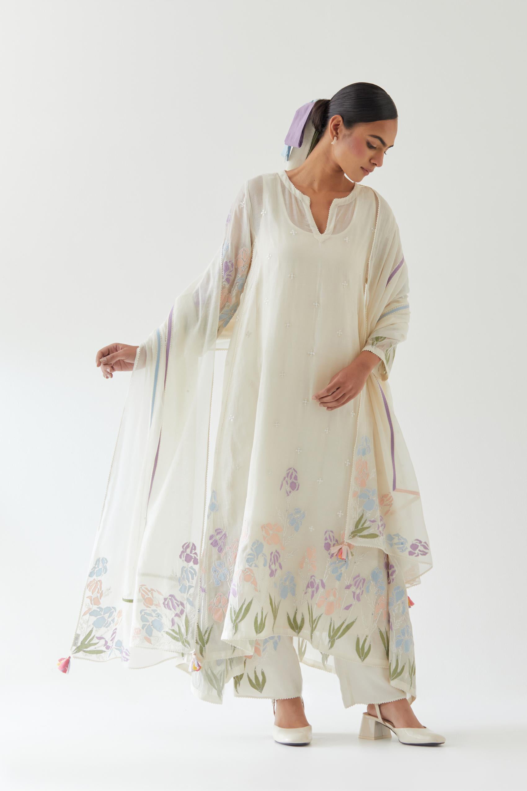 Off white cotton chanderi easy fit, asymmetric hem, paneled kurta set with applique work at hem and sleeves.