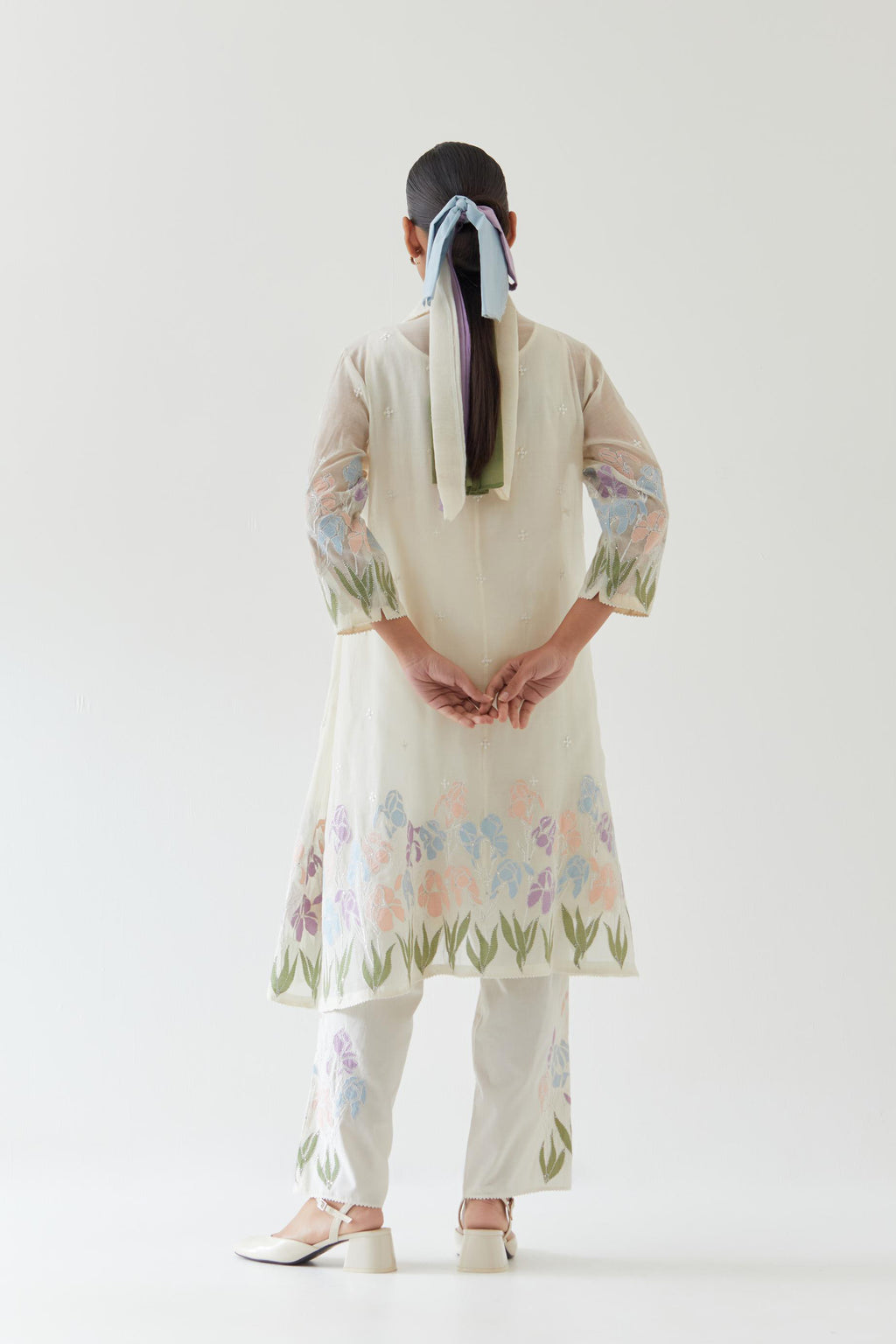Off white cotton chanderi A-line short kurta set with applique work at hem, highlighted with bead & sequins work.
