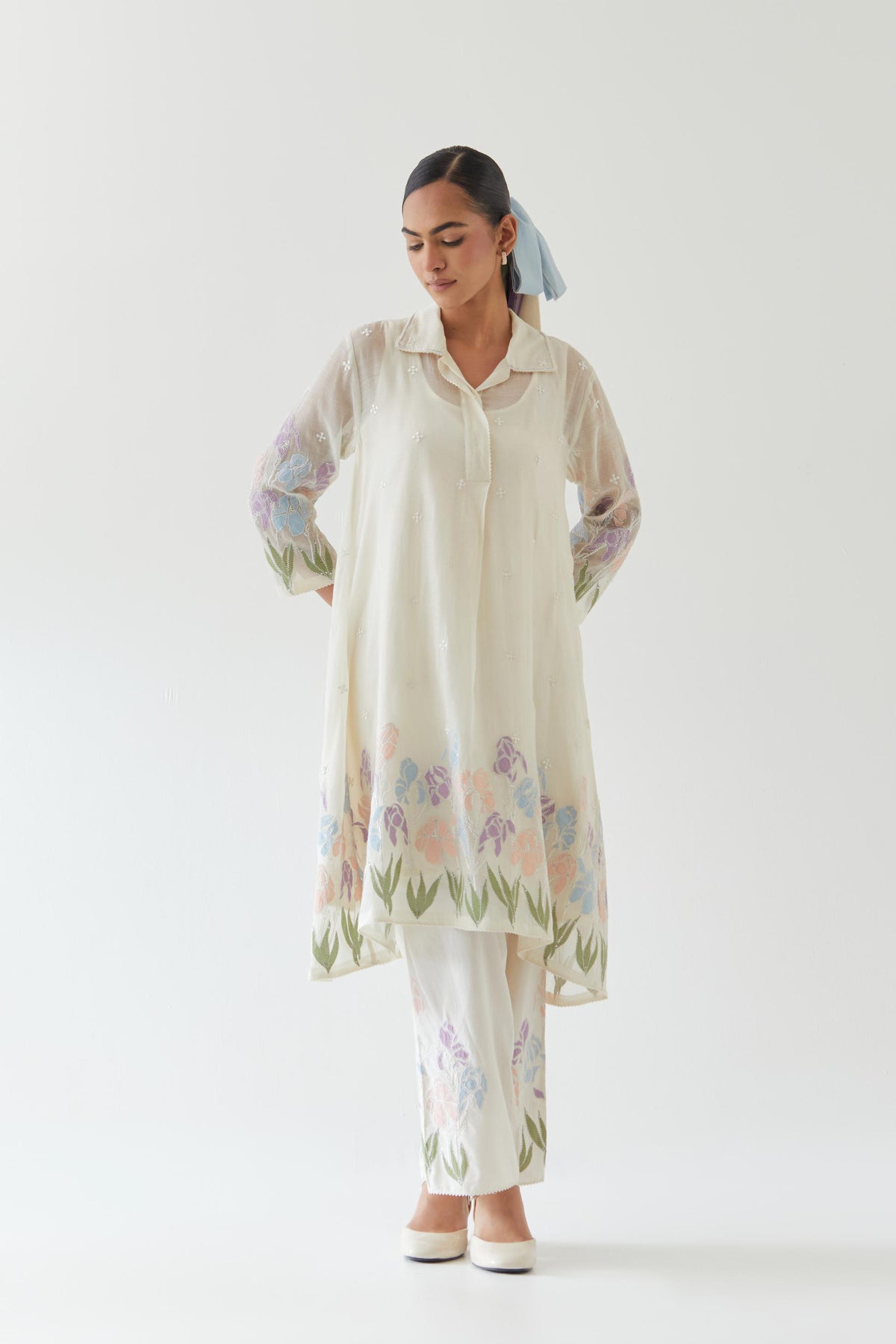 Off white cotton chanderi A-line short kurta set with applique work at hem, highlighted with bead & sequins work.