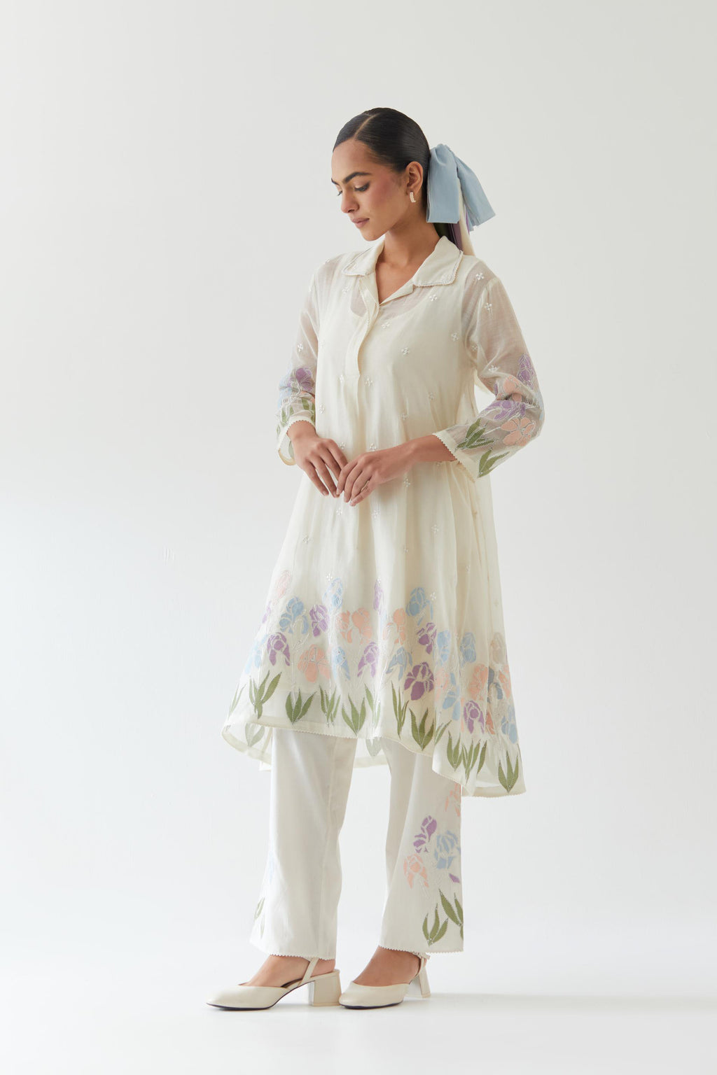 Off white cotton chanderi A-line short kurta set with applique work at hem, highlighted with bead & sequins work.