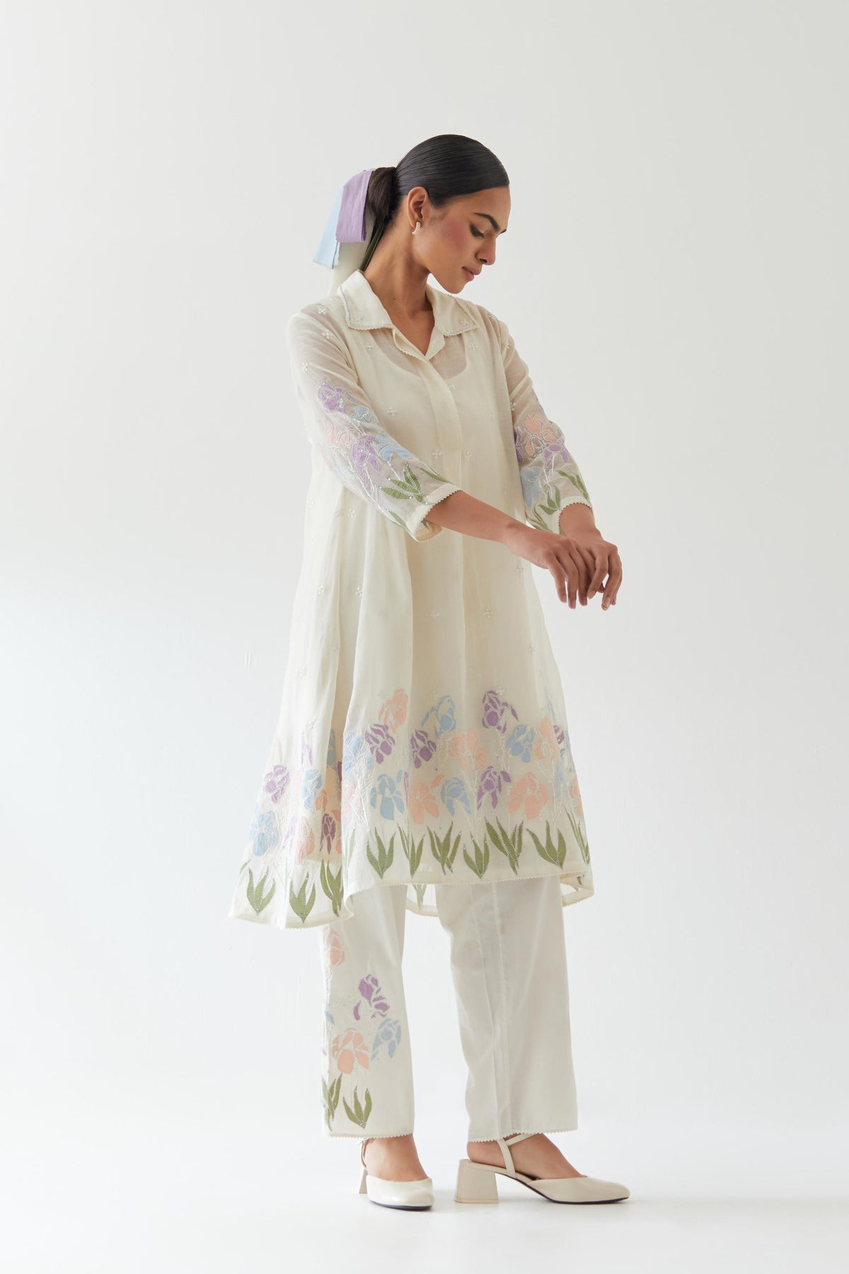 Off white cotton chanderi A-line short kurta set with applique work at hem, highlighted with bead & sequins work.
