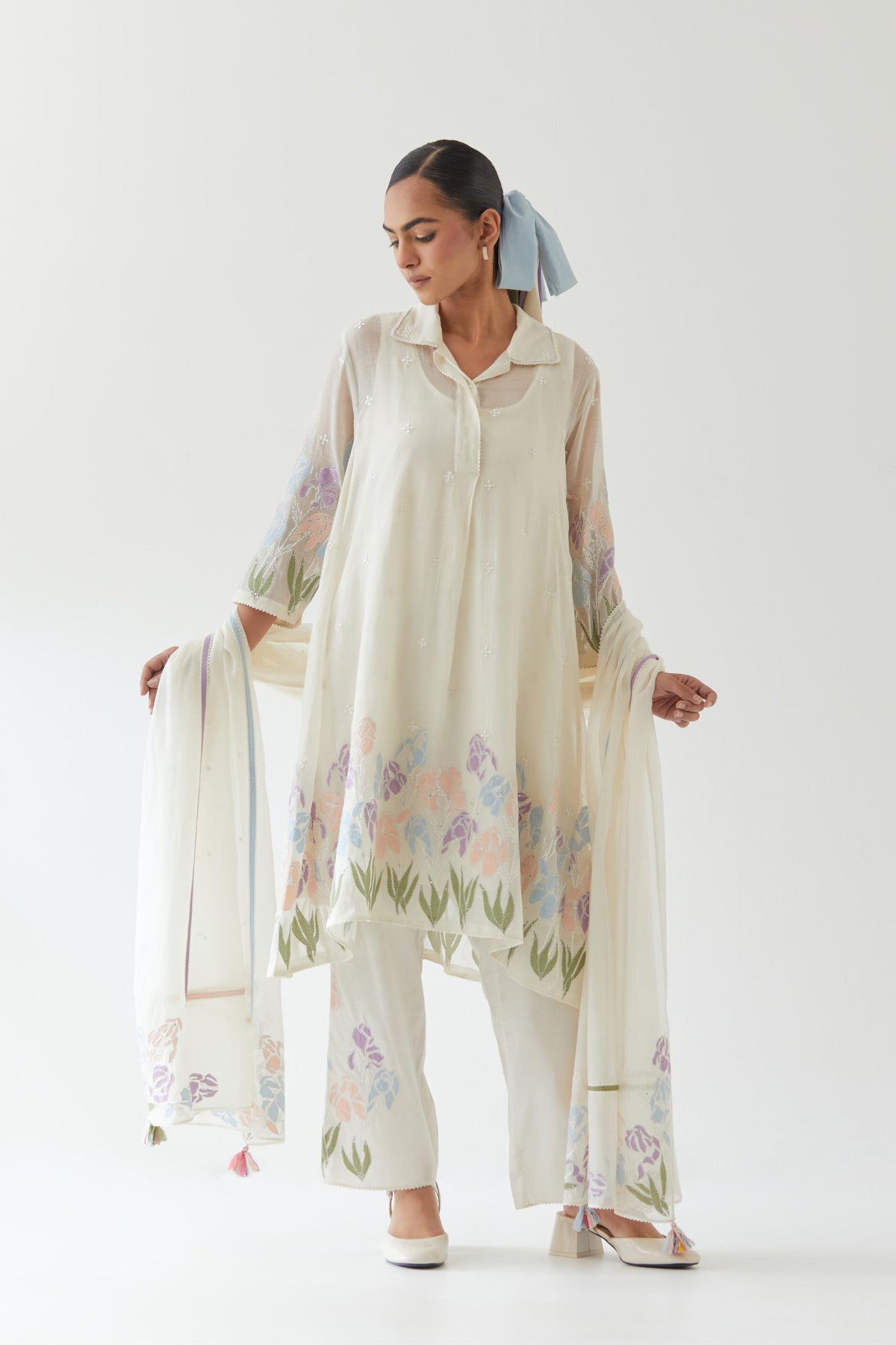 Off white cotton chanderi A-line short kurta set with applique work at hem, highlighted with bead & sequins work.