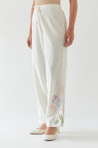 Off white cotton straight pants detailed with multi colored applique, highlighted with bead & sequins work.