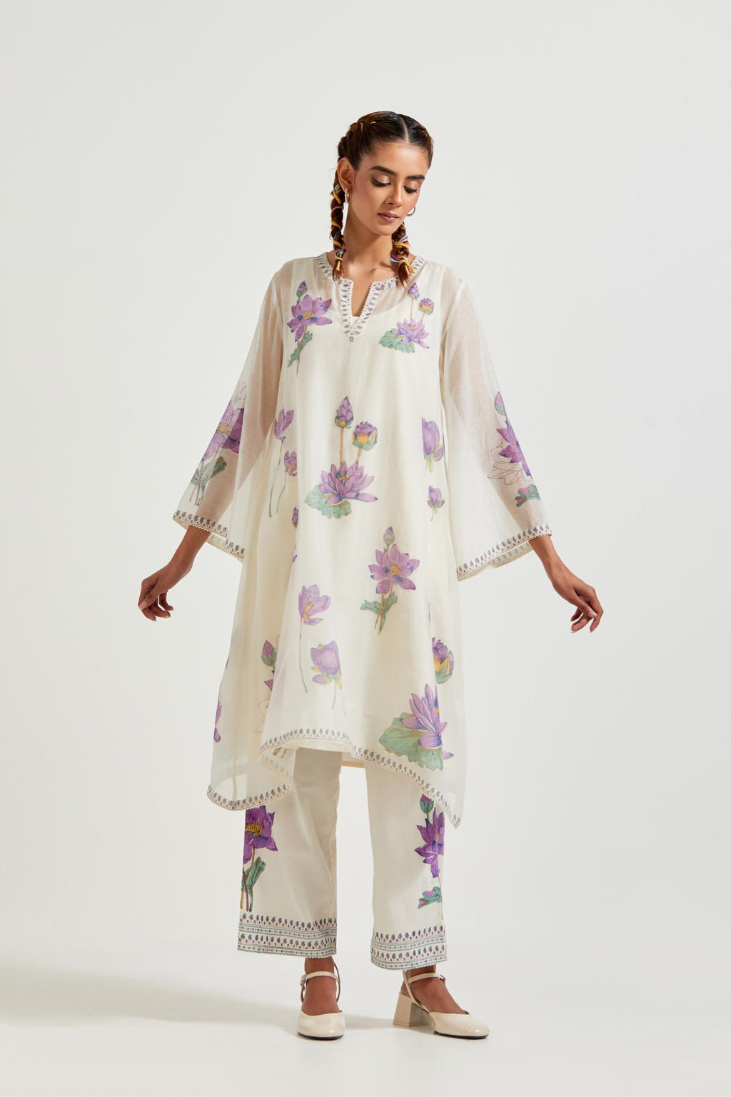 Off white cotton chanderi A-line kurta set features with all-over purple and green lotus flower hand block print.