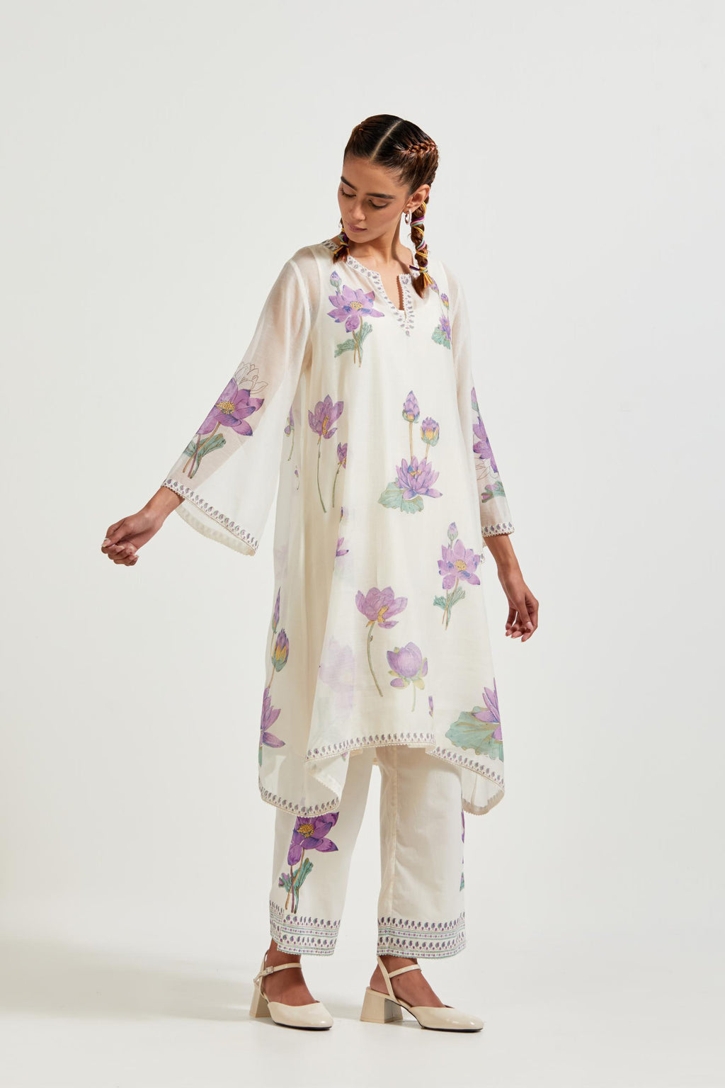 Off white cotton chanderi A-line kurta set features with all-over purple and green lotus flower hand block print.